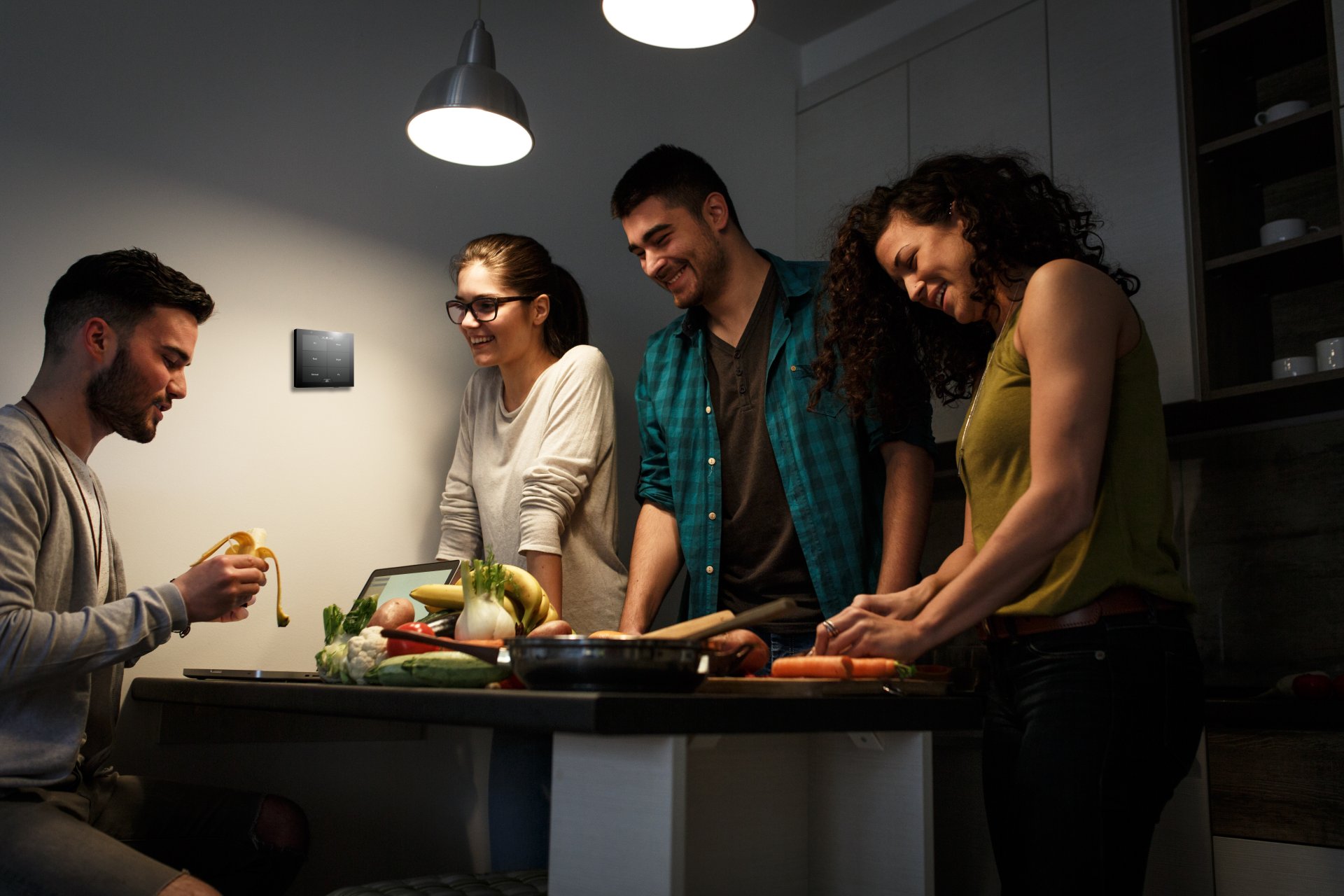 Group around table in the evening with Violet SmartSwitch Lite wall mounted